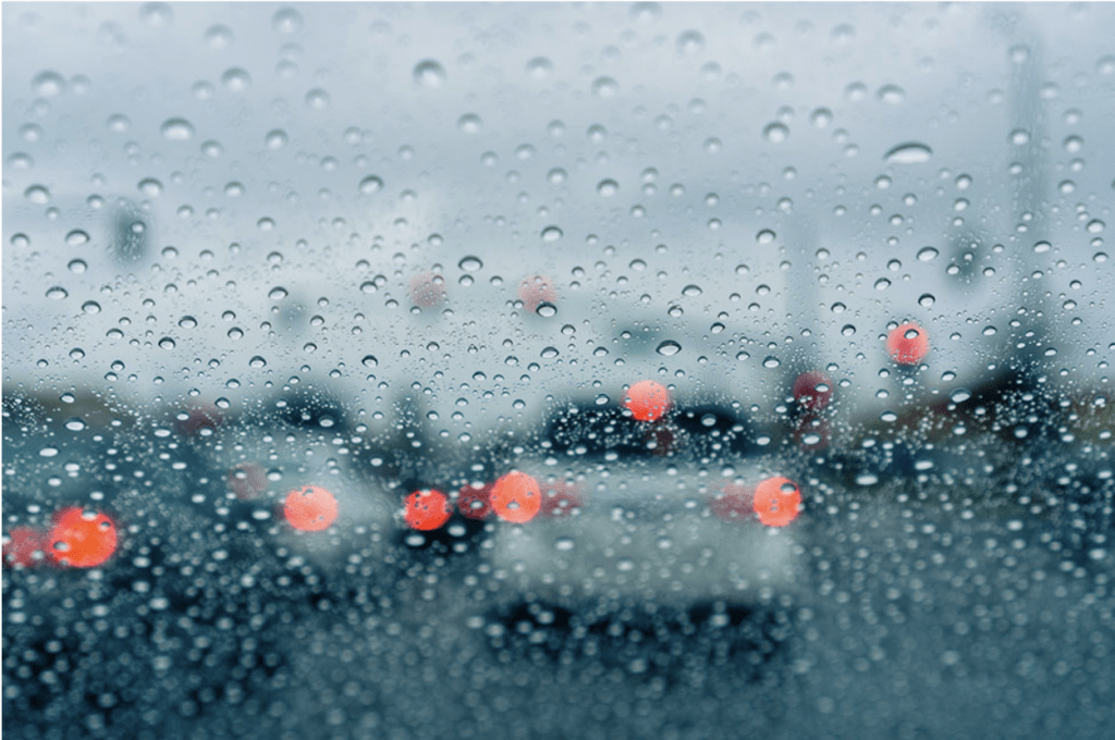 Raindrops on the windshield while driving on a rainy day
